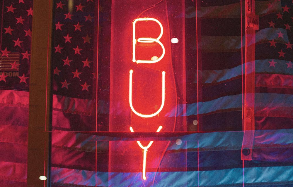 Buy, in neon letters